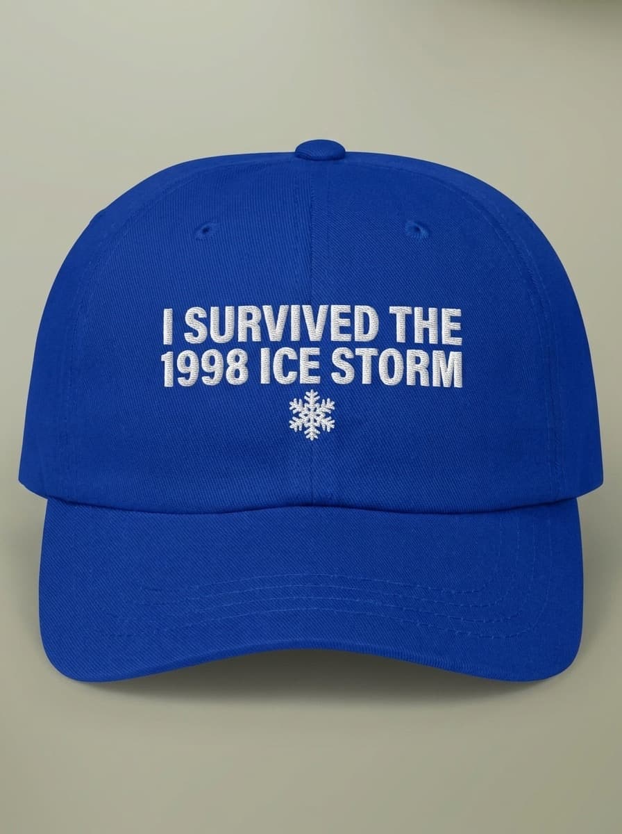 Royal blue dad hat embroidered in white with I SURVIVED THE 1998 ICE STORM above a snowflake.