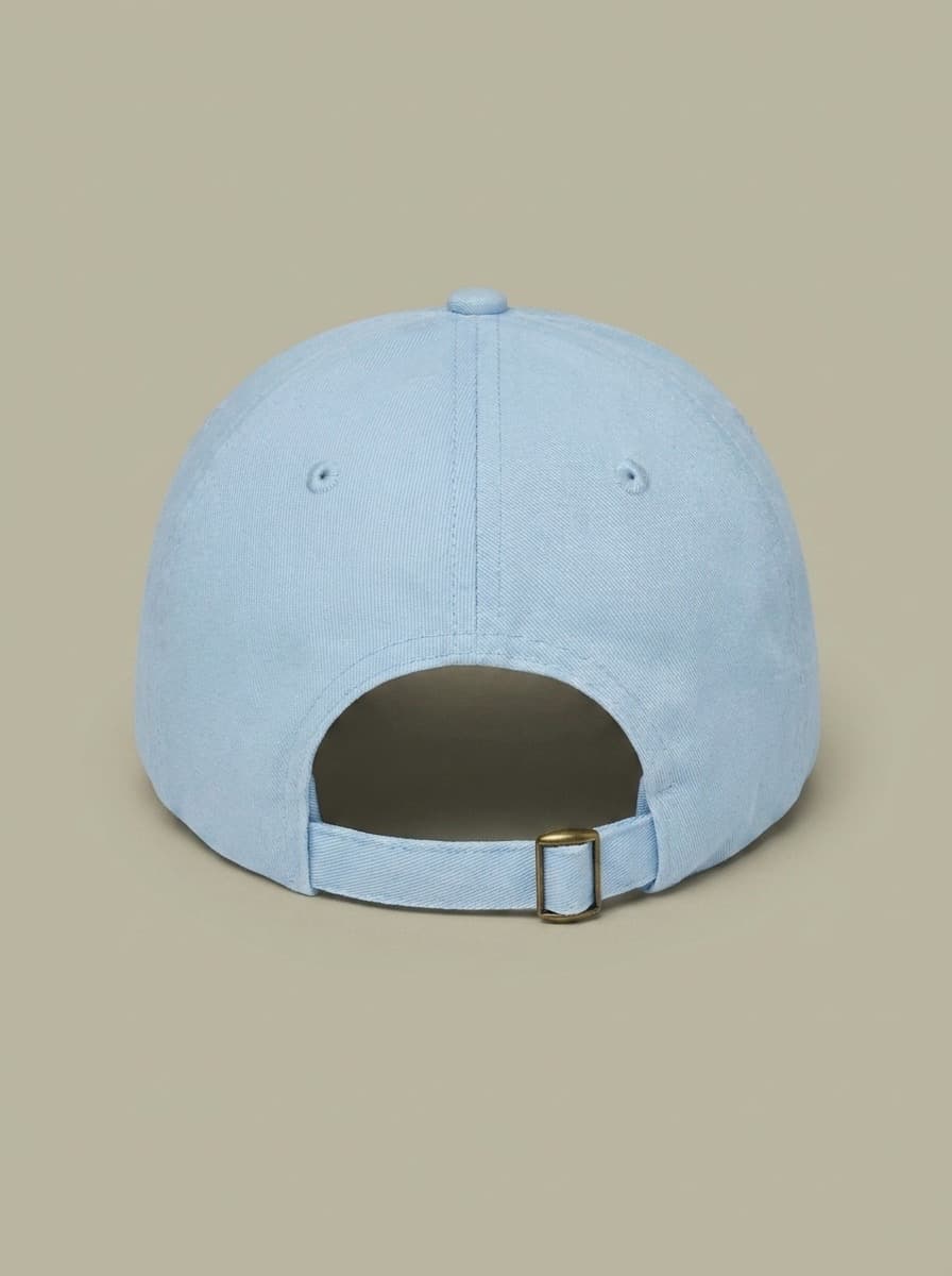 Back of the pale blue junior curling hat, showing the adjustable strap.