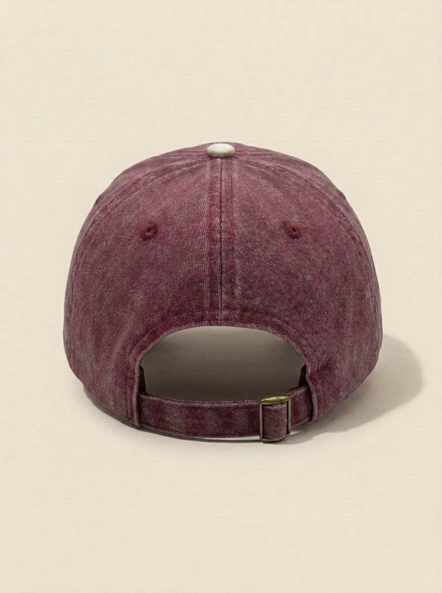 Back of the maroon and cream probably hat, showing the adjustable strap.